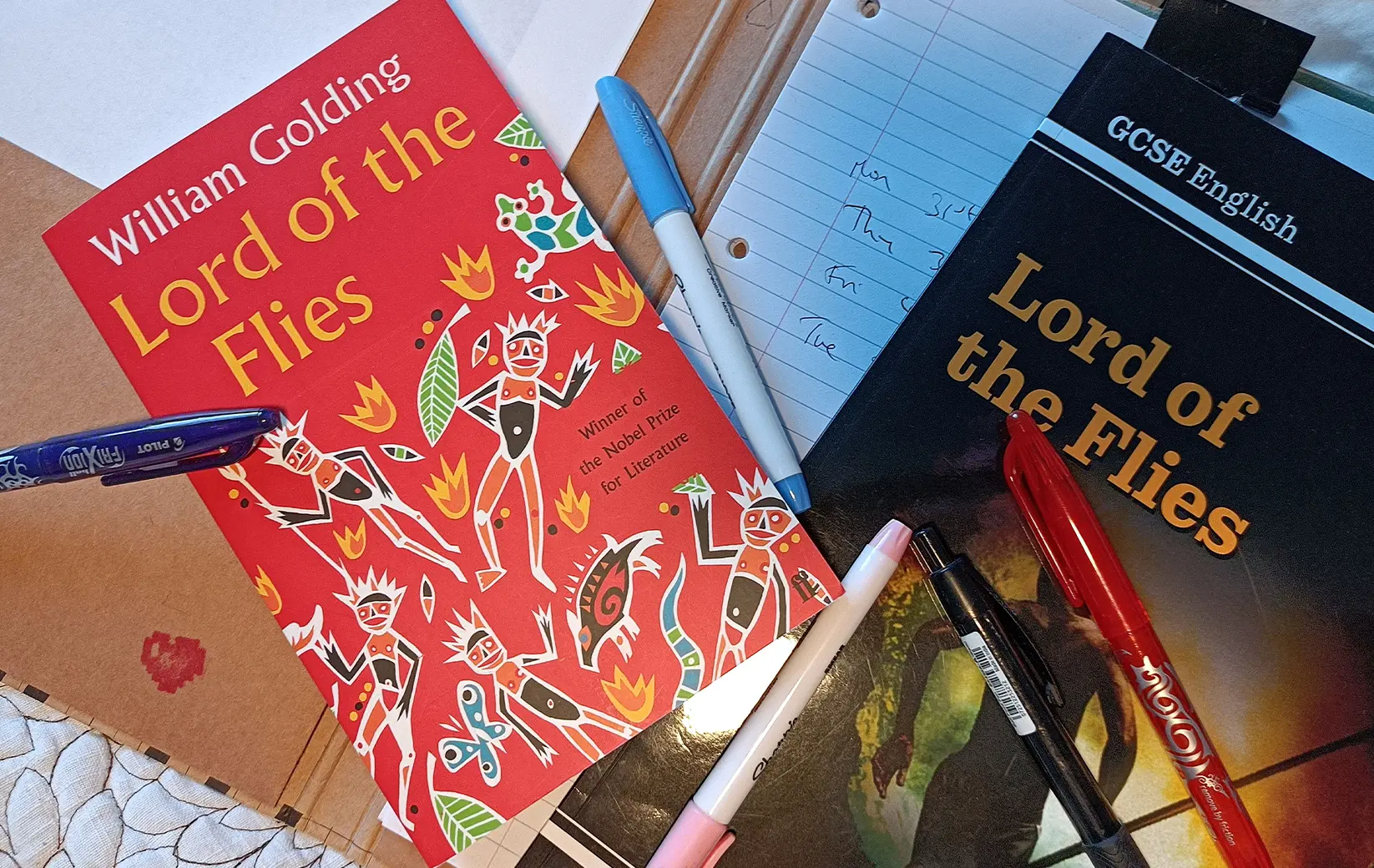 Two copies of Lord of the Flies with pens and notes on a desk