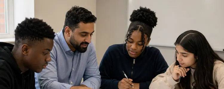 Tutor helping students with their schoolwork in a classroom